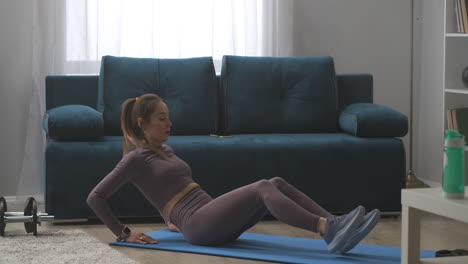 exercise-for-abdominal-muscles-young-athletic-woman-is-sitting-on-floor-and-lifting-torso-and-legs-healthy-lifestyle-home-training